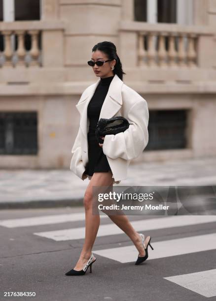 Thanya Wong seen wearing Gentle Monster black sunglasses, Polène Paris gold jewelry / earrings, Vautrait cream white oversized wool short coat /...