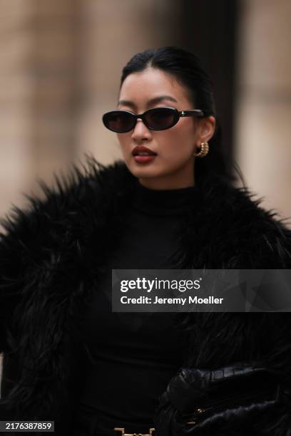 Thanya Wong seen wearing Gentle Monster black sunglasses, Polène Paris gold jewelry / earrings, Vautrait black oversized wool long coat with fur...