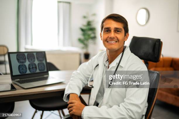 portrait of mid adult doctor man on medical clinic at hospital - neurologist stock pictures, royalty-free photos & images
