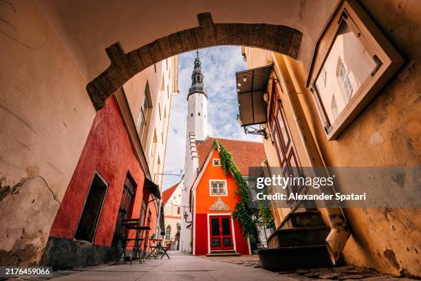 wide angle view of holy spirit church seen through the arch in tallinn old town, estonia - tallinn stock pictures, royalty-free photos & images