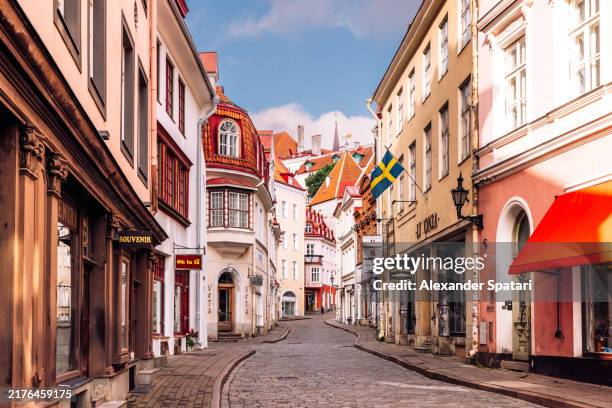 cobbled street in tallinn old town on a sunny morning, estonia - tallinn stock pictures, royalty-free photos & images