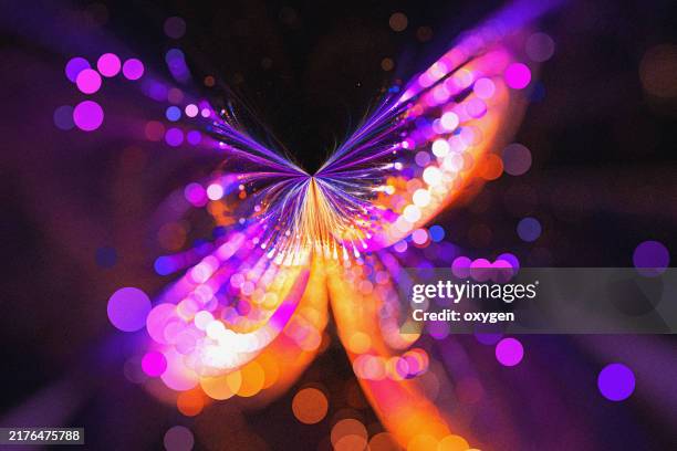 abstract butterfly flower purple blue fractal on black background. abstract design featuring a glowing light burst with vibrant purple and orange bokeh effects, creating a dynamic, energetic, and mesmerizing composition against a dark background. - butterfly on black stock pictures, royalty-free photos & images