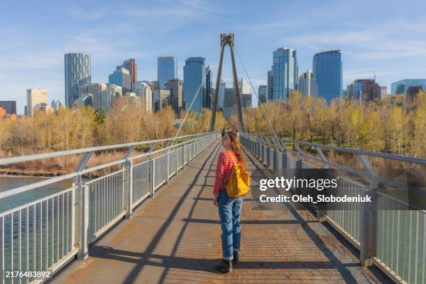 woman exploring calgary city in springtime - calgary stock pictures, royalty-free photos & images