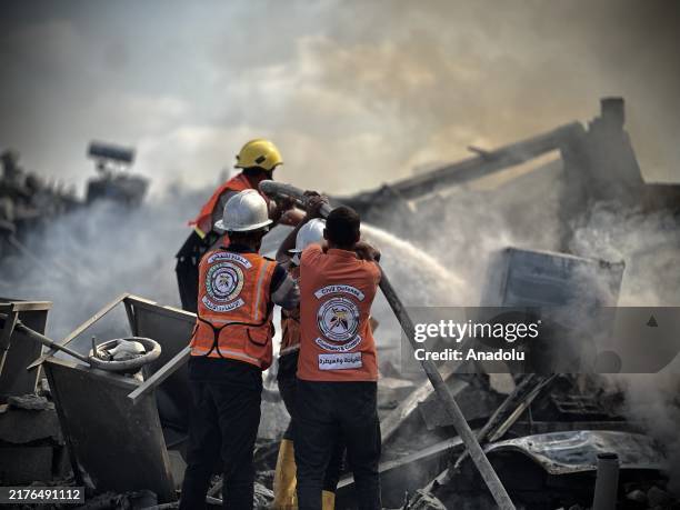 Civil defense teams conduct fire extinguishing and search and rescue operations after Israeli army's attack, which caused a fire to break out in a...