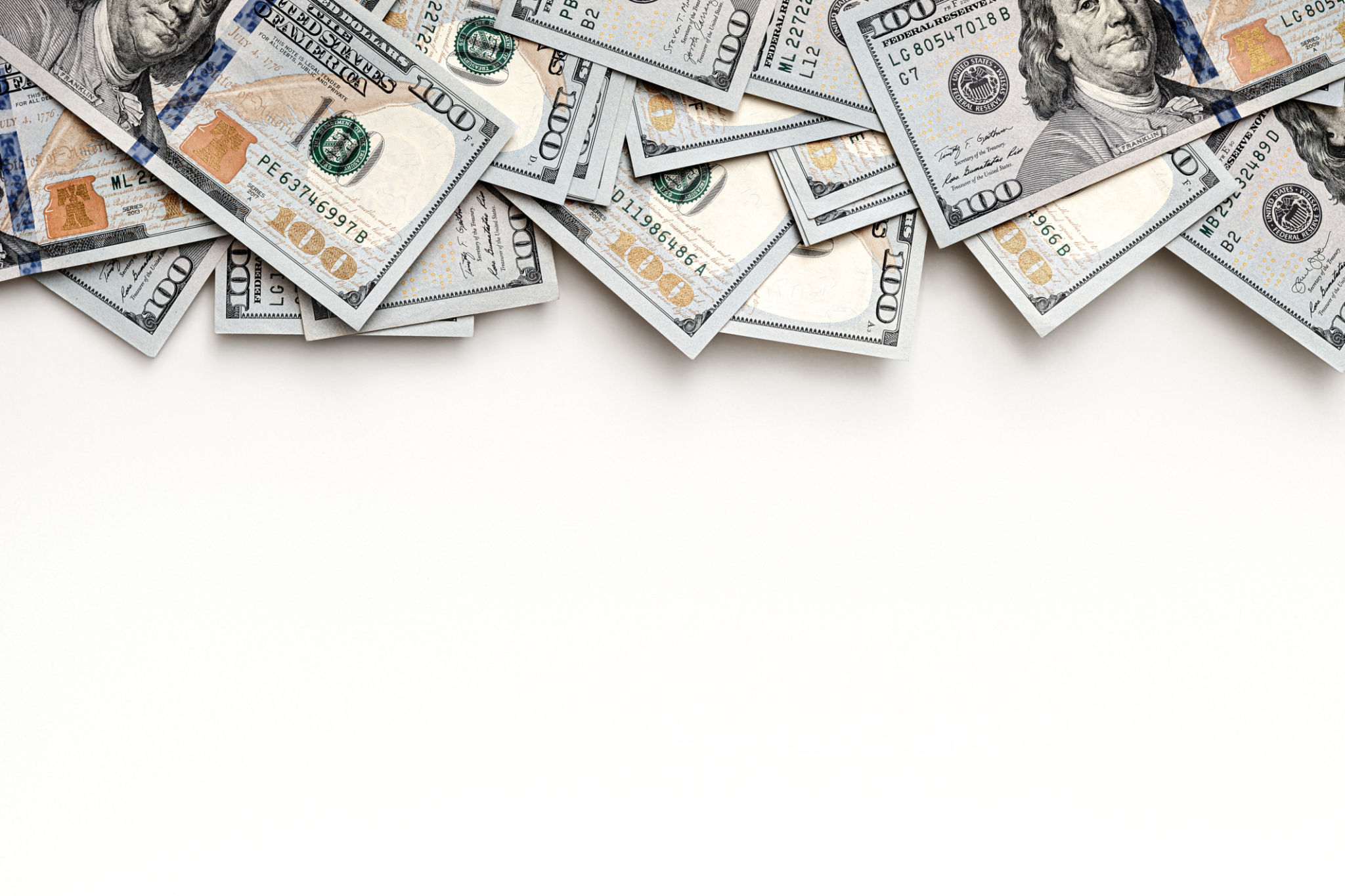 US paper currency with close-up details of one hundred dollar bills. Top view layout with negative space for financial concepts. Banknotes positioned at the top, leaving room for text. US paper currency with close-up details of one hundred dollar bills. Top view layout with negative space for financial concepts. Banknotes positioned at the top, leaving room for text.