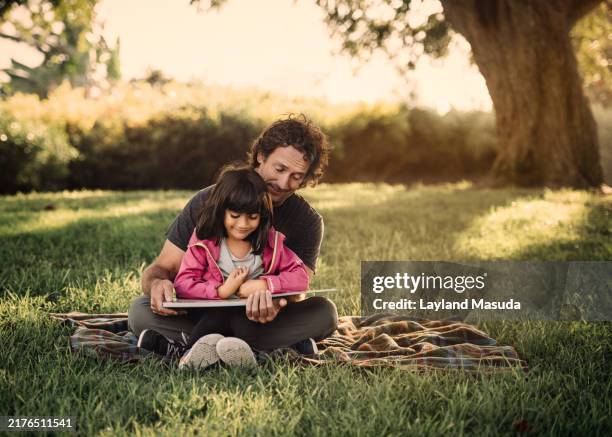 dad teaching daughter to read - torrance stock pictures, royalty-free photos & images