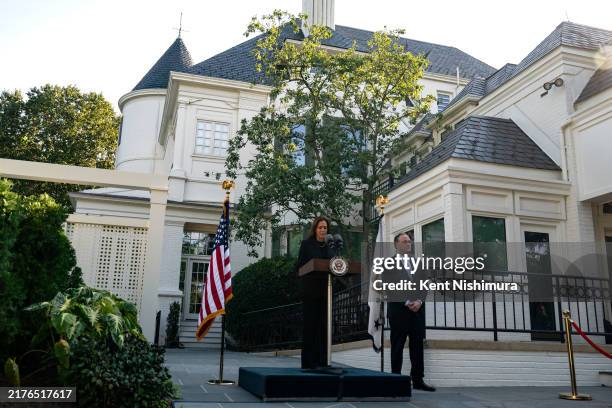 Vice President Kamala Harris speaks as Second Gentleman Doug Emhoff looks on before they plant a pomegranate tree at the Vice President's residence...