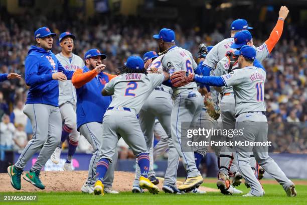 The New York Mets celebrate after beating the Milwaukee Brewers 4-2 in Game Three of the Wild Card Series at American Family Field on October 03,...