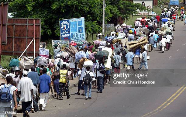 Refugees flee fighting by walking into Monrovia July 19, 2003 just outside Monrovia, Liberia. In an unexpected move, rebels attacked the capital this...