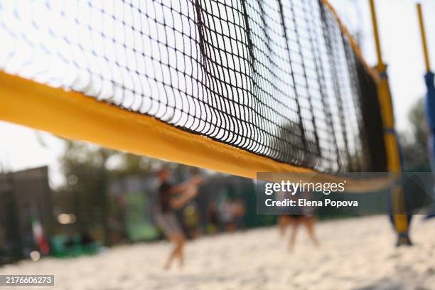 full frame beach volleyball and beach tennis sandy court with yellow sports net - beach volley foto e immagini stock