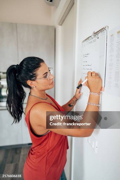 checking the appointment on the wall - best single word stock pictures, royalty-free photos & images