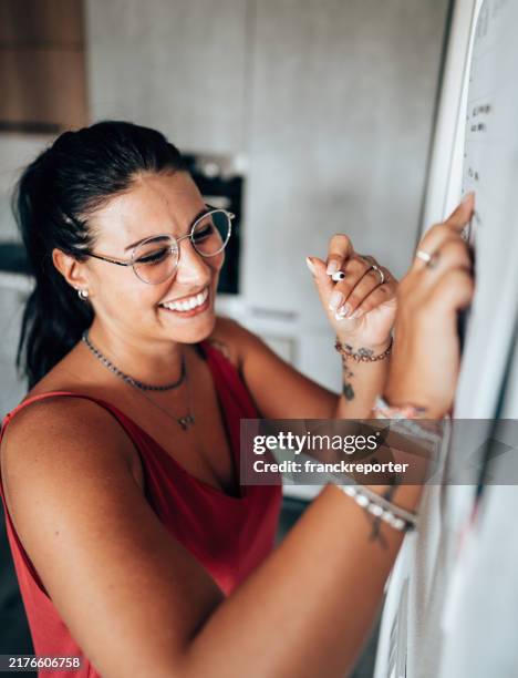 checking the appointment on the wall - best single word stock pictures, royalty-free photos & images