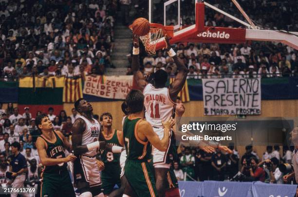 Lithuanian basketball players Alvydas Pazdrazdis , Gintaras Krapikas , and Darius Dimavicius in action against American basketball players Patrick...
