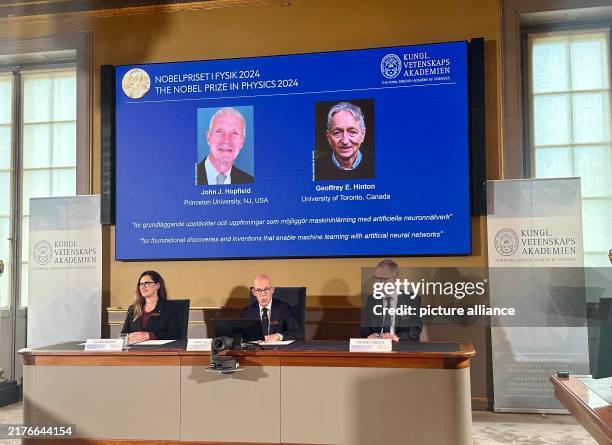 October 2024, Sweden, Stockholm: Images of physicists John J. Hopfield and Geoffrey E. Hinton are shown on the screen during the press conference...