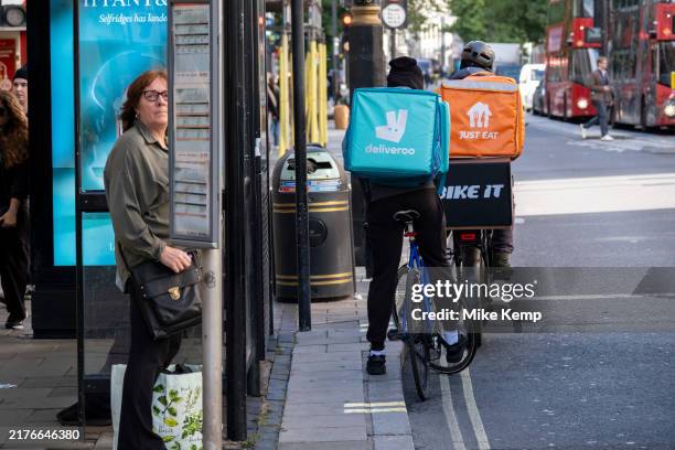 Deliveroo and Just Eat takeaway delivery cycle couriers on Oxford Street on 6th October 2024 in London, United Kingdom. Just Eat Limited is a British...