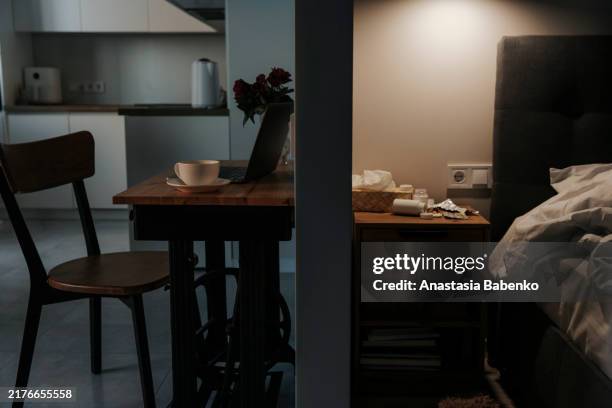 image of apartment divided by wall. kitchen and bedroom view - nachttisch stock-fotos und bilder