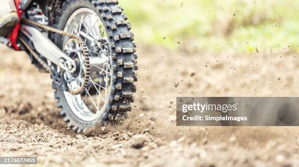 a motocross bike rolls stones and mud at the start of the race - moto x enduro stock pictures, royalty-free photos & images