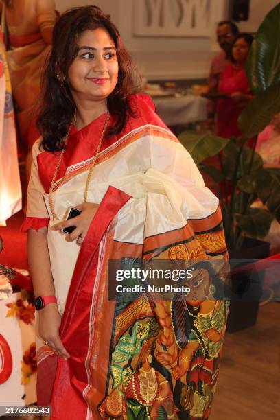 Bengali Hindu woman wears a saree with the image of the Goddess Durga during the Durga Puja festival at a pandal in Mississauga, Ontario, Canada, on...
