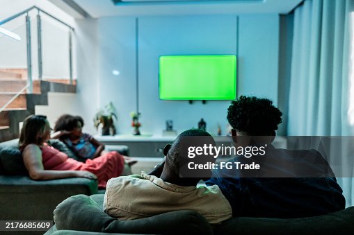Family watching TV at home Family watching TV at home