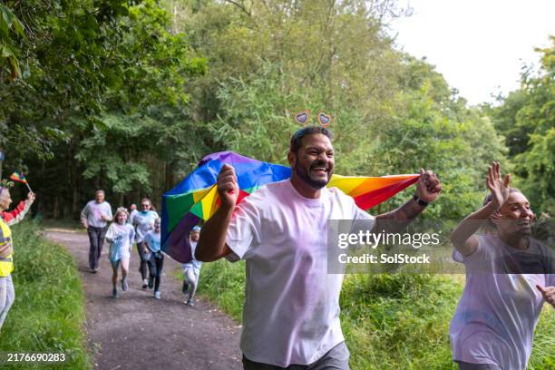 smiling with pride - gay pride symbol stock pictures, royalty-free photos & images