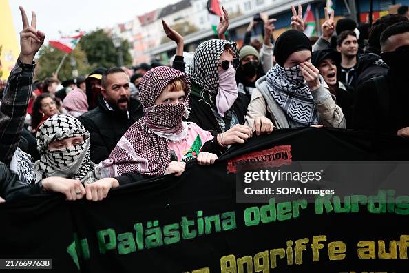 Pro-Palestinian protesters wearing Palestinian keffiyeh Pro-Palestinian protesters wearing Palestinian keffiyeh