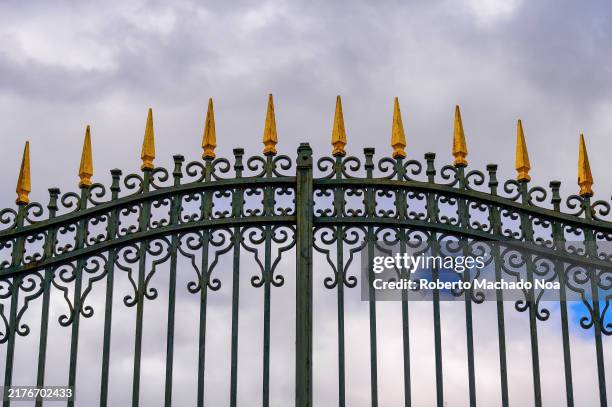 Entrance gate to the Royal Palace with a low-angle view of the decorations in the ancient metalwork.