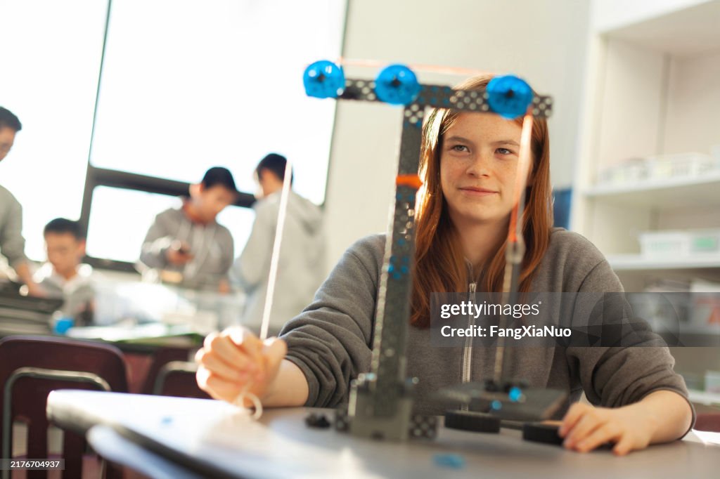 Construct Physics Teenage Girl In High School Classroom Making Physics Construction ...