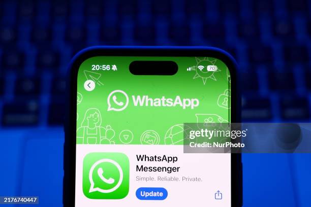 Laptop keyboard and WhatsApp on App Store displayed on a phone screen are seen in this illustration photo taken in Poland on October 8, 2024.