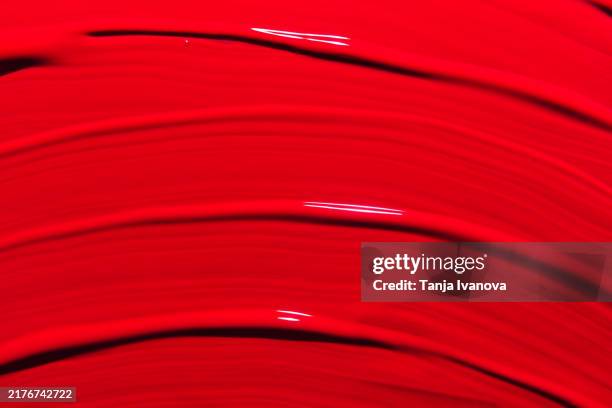 red lipstick background. beauty cosmetic texture. makeup and skin care products. textured red paint brush stroke - red lipstick stock pictures, royalty-free photos & images