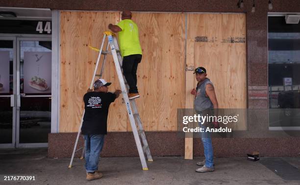 Workers board up a business ahead of Hurricane Milton's expected landfall in St. Petersburg, Florida, US, on October 8, 2024.