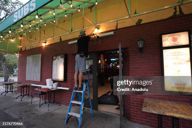 Workers board up a business ahead of Hurricane Milton's expected landfall in St. Petersburg, Florida, US, on October 8, 2024.