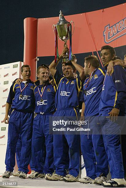 Adam Hollioake of Surrey Lions and his team-mates celebrate with the Twenty20 trophy at the end of the Twenty20 Cup final between Surrey and...