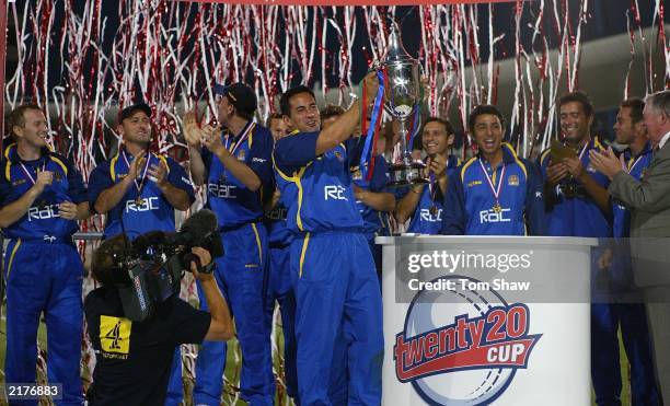 Adam Hollioake, the Surrey captain, and the rest of the team celebrate with the trophy after the Surrey v Warwickshire Final of the Twenty20...