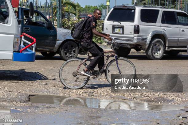 Man rides his bicycle down the street in Port-au-Prince after the Savien gang attack in Pont-Sond on Oct. 3, on October 08, 2024 in Port-au-Prince,...