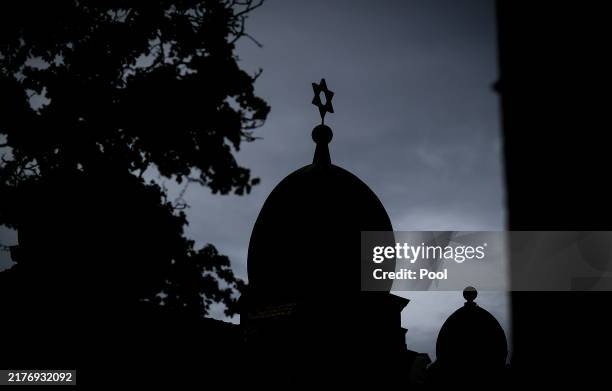The silhouette of a synagogue in Halle is seen after a memorial for the victims of the 2019 shooting at the synagogue in Halle , eastern Germany on...