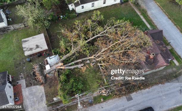 In this aerial view, a tree lays on top of a house as the area recovers from the aftermath of Hurricane Helene on October 05, 2024 in Augusta,...