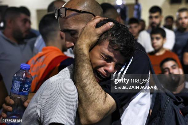 Boy cries at a hospital morgue after four men were killed in a vehicle by Israeli special forces in Nablus, in the occupied West Bank, on October 9,...