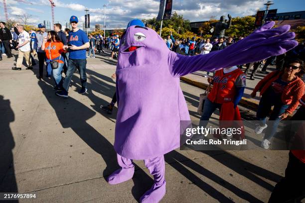 Fan dressed as Grimace poses for a photo prior to Game 4 of the Division Series presented by Booking.com between the Philadelphia Phillies and the...