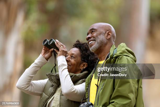 couple bird watching while hiking - african american man hike stock pictures, royalty-free photos & images
