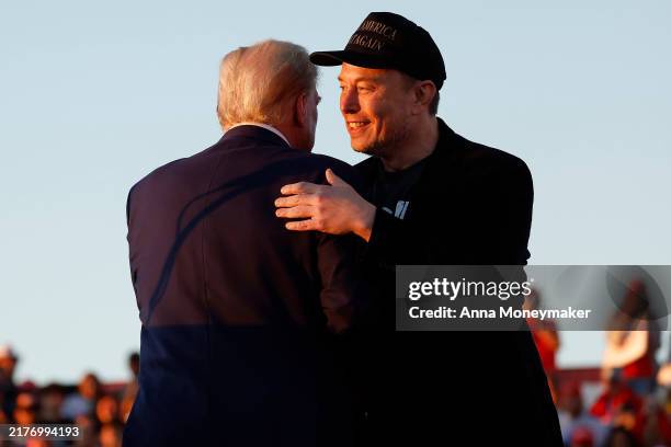 Elon Musk embraces Republican presidential nominee, former President Donald Trump during a campaign rally at the Butler Farm Show fairgrounds on...