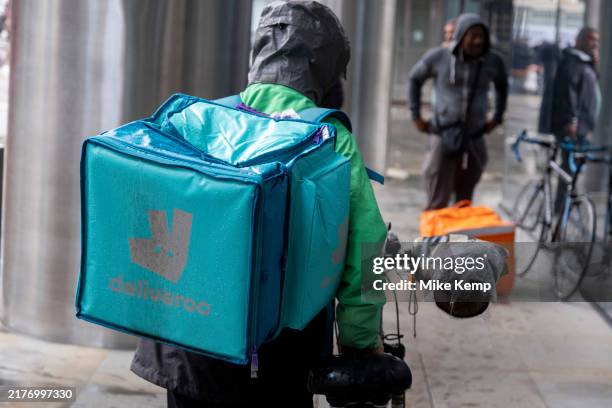 Deliveroo takeaway delivery cycle courier on 8th October 2024 in London, United Kingdom. Deliveroo acts as an intermediary between independent...