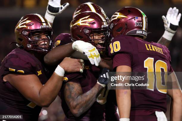 Wide receiver Jordyn Tyson of the Arizona State Sun Devils celebrates with quarterback Sam Leavitt and offensive lineman Leif Fautanu after scoring...