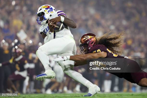 Linebacker Zyrus Fiaseu of the Arizona State Sun Devils sacks quarterback Jalon Daniels of the Kansas Jayhawks during the second half at Mountain...