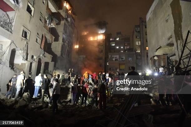 People conduct search and rescue works around the demolished apartment building aftermath of Israeli attack on the Nowayri neighborhood of Beirut,...