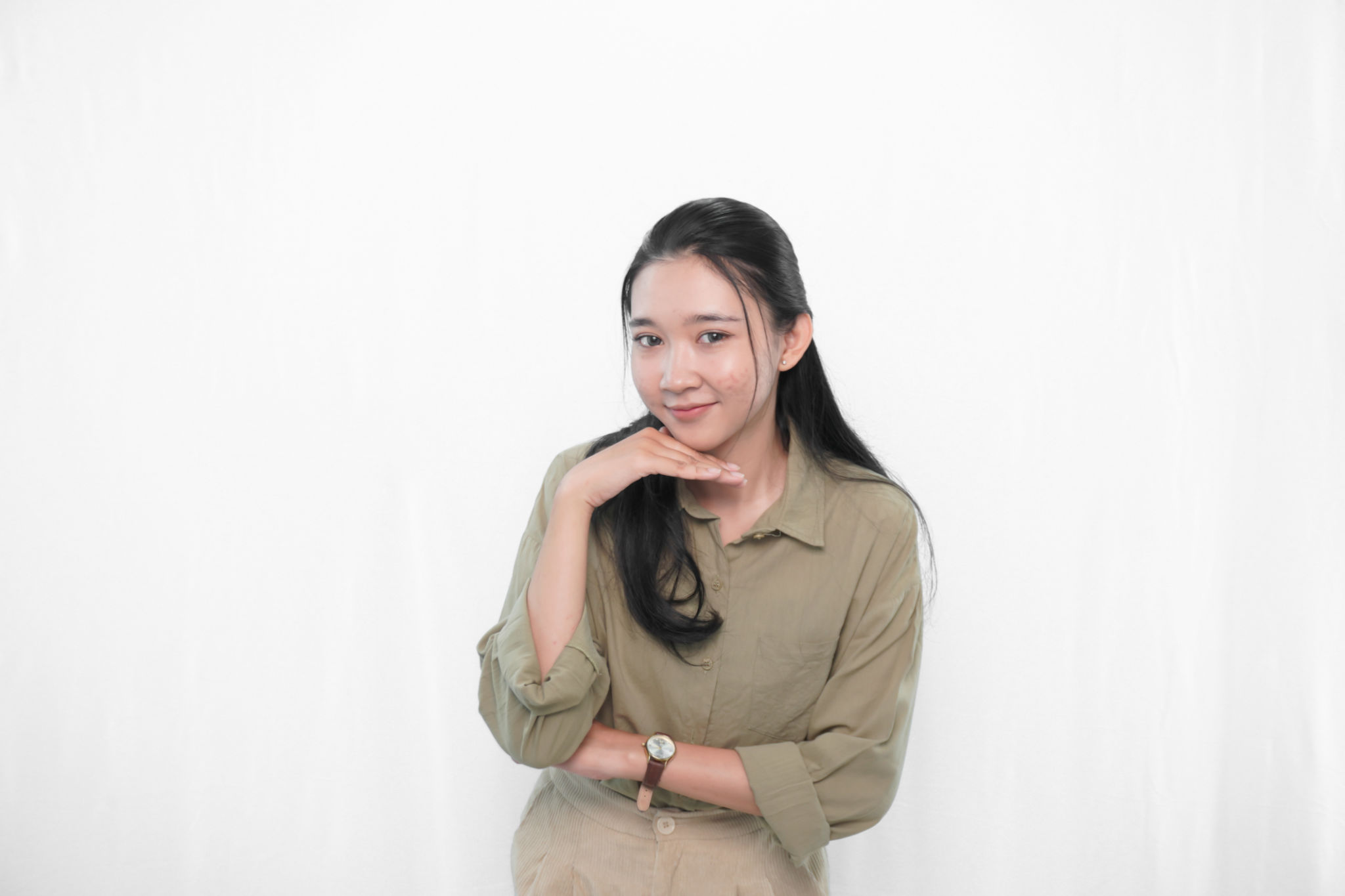 Expression of Indonesian Asian woman in green dress in studio Expression of Indonesian Asian woman in green dress in studio