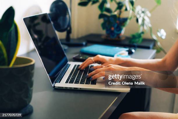 hands typing on laptop keyboard in modern workspace - touch pad stock pictures, royalty-free photos & images