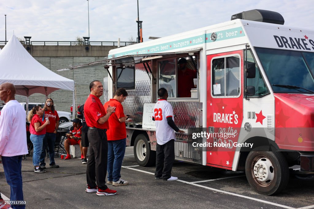 A crowd of people tailgating at a University of Louisville football game at L and N Cardinal Stadium in Louisville, Kentucky