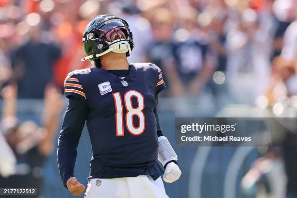 Caleb Williams of the Chicago Bears reacts after throwing a touchdown pass to DJ Moore against the Carolina Panthers during the second quarter at...