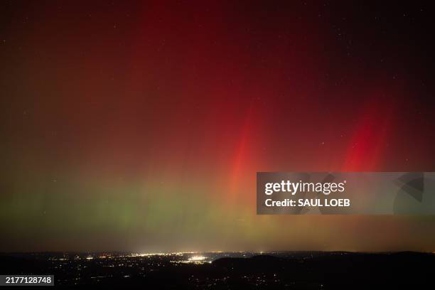 Aurora borealis, or northern lights, produced by a solar geomagnetic storm are seen from Shenandoah National Park in Rileyville, Virginia, on October...
