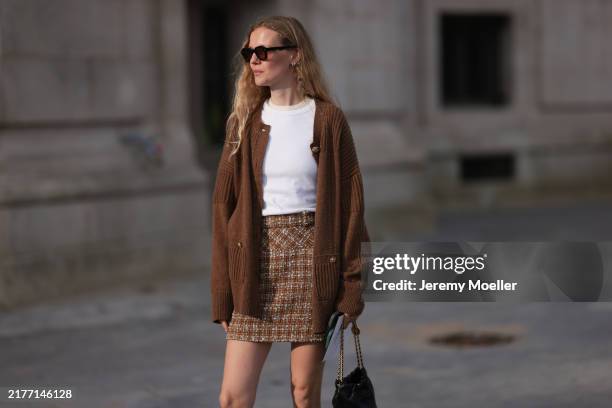 Marie von Behrens is seen wearing a brown plaid skirt, with a white top, a long brown cardigan, with a black Chanel handbag and black-brown...